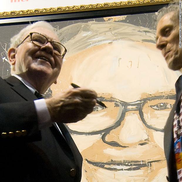 Warren adds his signature to the canvas