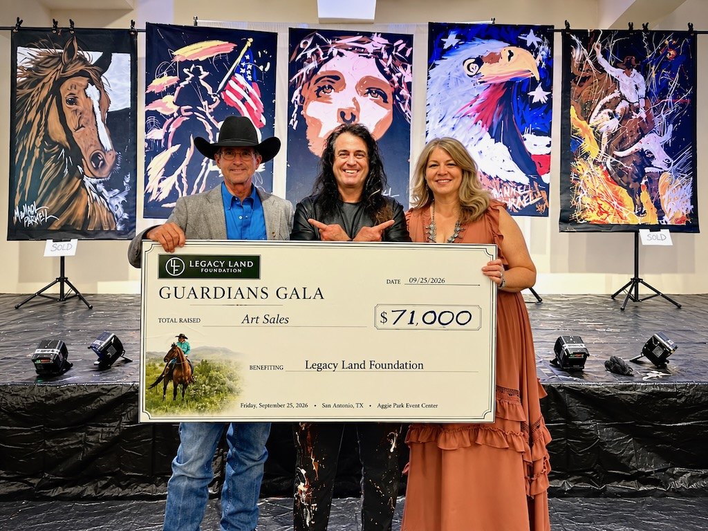 Michael Israel on stage with two guests holding a $71,000 Guardians Gala check