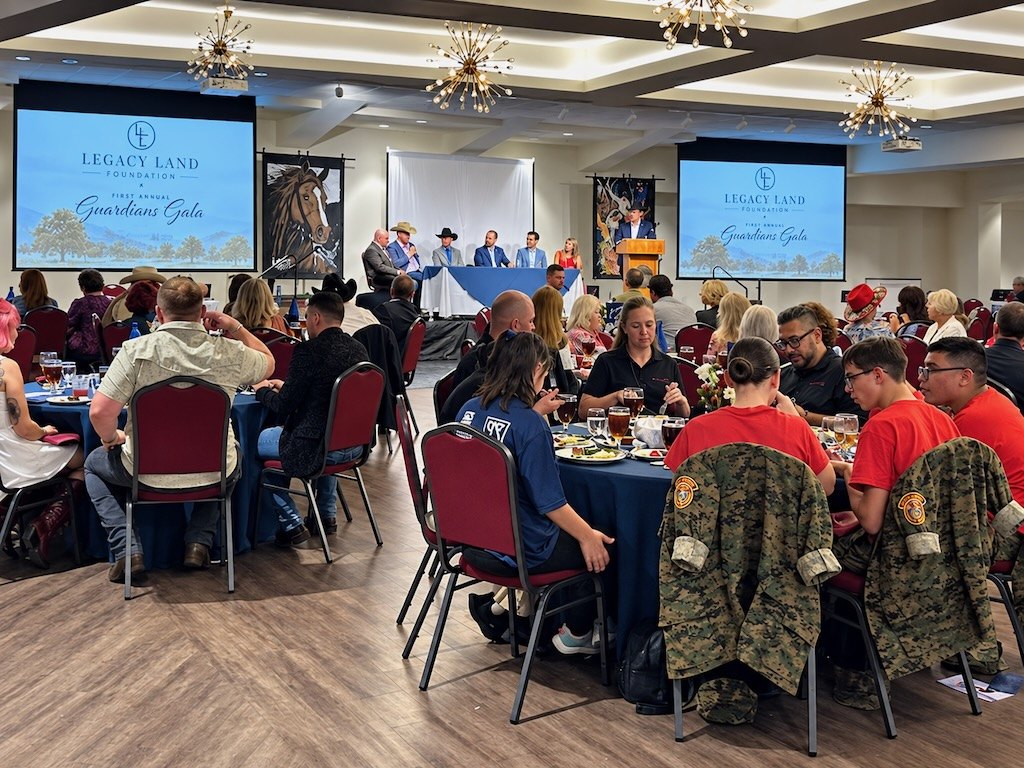 Guests at dinner tables in the Guardians Gala ballroom at Aggie Park Event Center