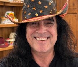 Michael Israel smiling in a stars-and-stripes cowboy hat