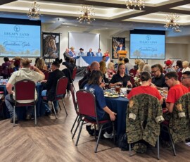 Guests at dinner tables in the Guardians Gala ballroom at Aggie Park Event Center